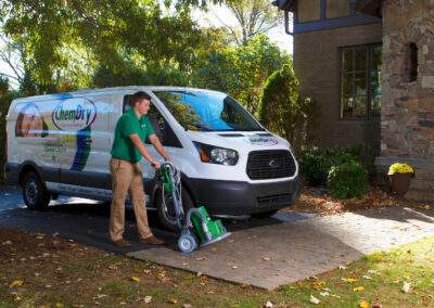 chem-dry employee parked outside of house removing equipment from van