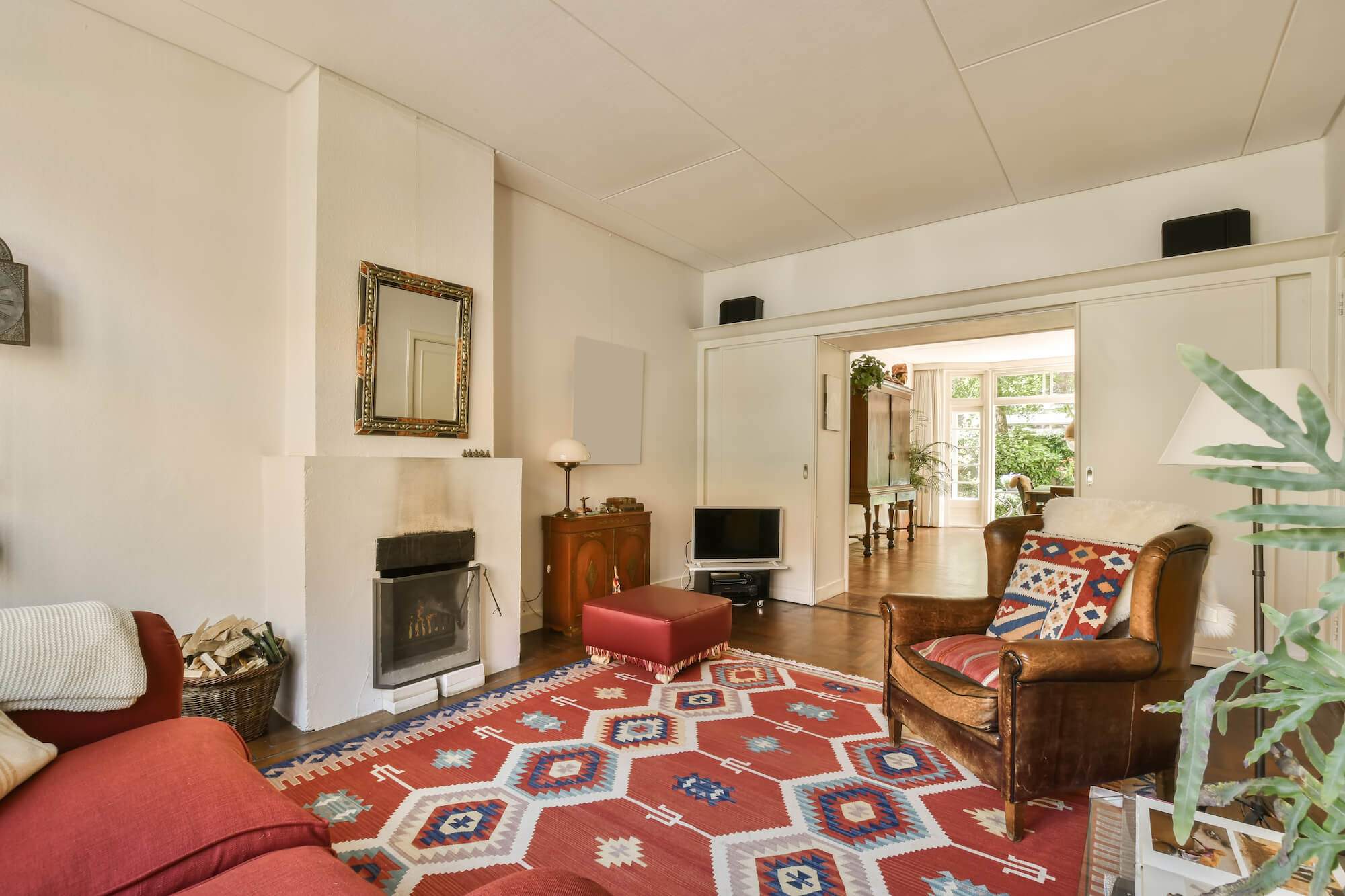 a-living-room-with-a-red-rug-and-a-fireplace-2023-11-27-05-00-02-utc living room after area rug cleaning