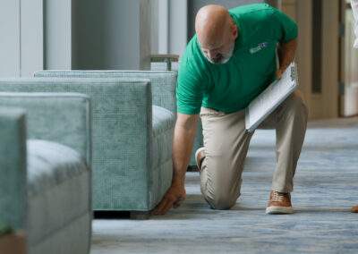 examining hotel carpet