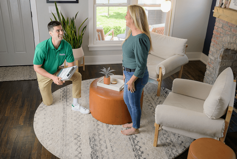 tech with woman on area rug