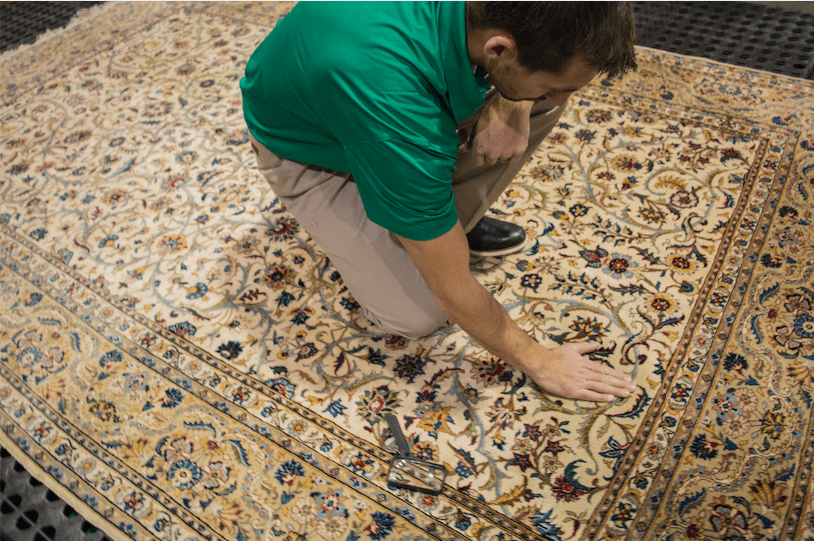 technician inspecting rug